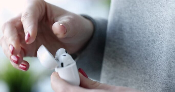 Wireless bluetooth headphones with charging case in hand