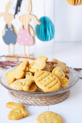 Close up of Easter cookies on a transparent saucer with decor in the background