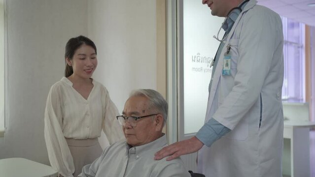 Granddaughter take her grandfather on wheelchair see the doctor or therapist at hospital.