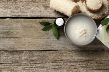 Flat lay composition with soaked rice on wooden table. Space for text