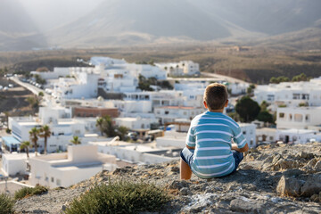 Fototapeta na wymiar Little kid looking andalusian village in Spain
