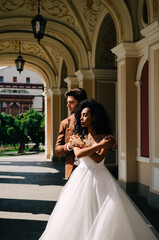 Obraz premium Beautiful African American girl in wight dress with her husband