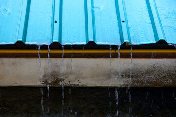 water drops on green corrugated metal roof