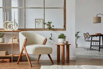 Stylish compositon of modern living room interior with frotte armchair, wooden commode, side table and elegant home accessories. Home staging. Template. Copy space..Dining room in the background..