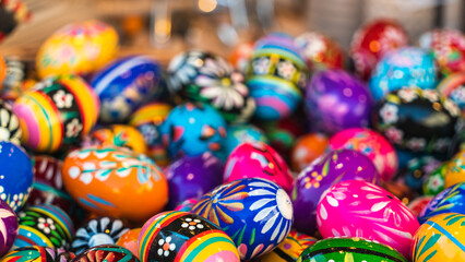 Colorful wooden Easter eggs at the Easter market in Krakow. Bright spring holiday background. Traditional symbols of Easter. Selective Focus