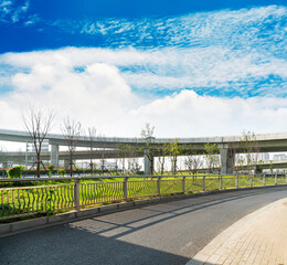 Concrete structure and asphalt road space under the overpass in the city