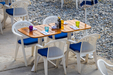 empty chairs and tables on the beach