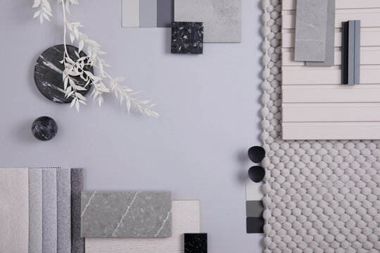 Elegant  flat lay composition in grey color palette with textile and paint samples, lamella panels and tiles. Architect and interior designer moodboard. Top view. Copy space.