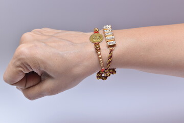 Indian man's hand wearing rakhi on raksha bandhan day. Rakhi is a traditional wrist band which is a...
