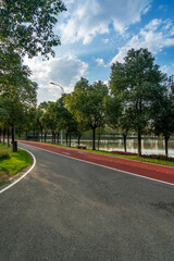 New pathway and beautiful trees track for running or walking and cycling relax in the park