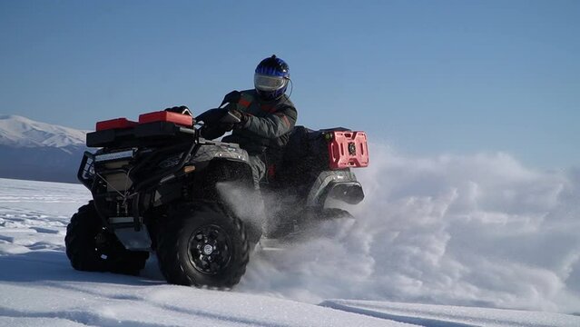 atv-riders drift in the snow