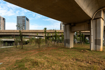 Concrete structure and asphalt road space under the overpass in the city