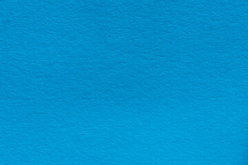 Naklejka na ściany i meble Blue textured paper background for the design. Macro photo of the surface of thick blue paper. Blue cardboard texture