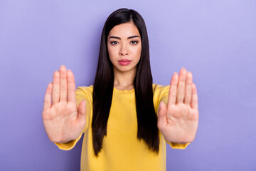 Photo of young girl show hands deny against refuse symbol ban block isolated over purple color background