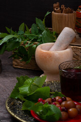 Still life of a marble mortar for spices, fresh herbs and vegetables