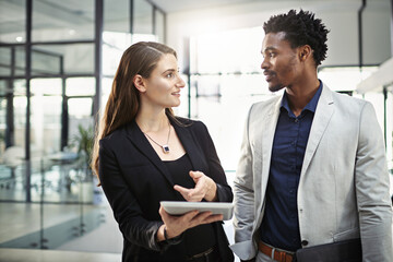You follow. Cropped shot of two businesspeople looking at a tablet in the office.