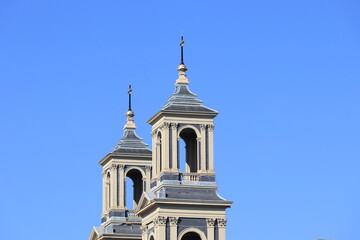 Fototapeta na wymiar Amsterdam Mozes en Aaaronkerk Church Towers Against a Blue Sky Close Up, Netherlands