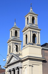 Fototapeta na wymiar Amsterdam Mozes en Aaronkerk Church Exterior Detail with Church Towers and Statue of Christ, Netherlands