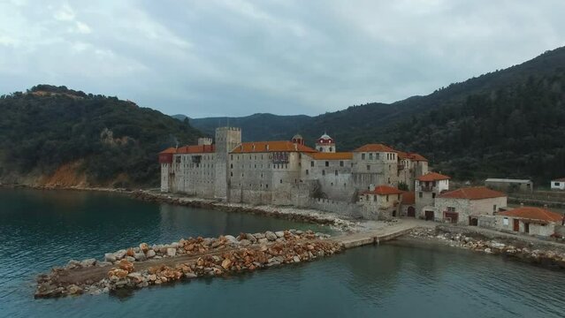 Amazing view of the Esfigmen monastery with the surrounding sea and mountains - panoramic drone shooting from above.