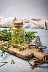 Glass jar of oil with fresh rosemary spice for tasty meals
