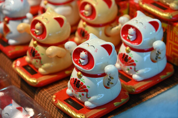 Welcoming cat oriental souvenir on sale in oriental fair selective focus Wealth Lucky Waving Kitty Maneki Neko