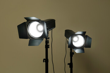 Modern spotlights against beige background. Professional stage equipment