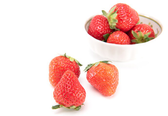 Fresh ripe strawberries in ceramic bowl and on white background. japanese fruit. Selective focus
