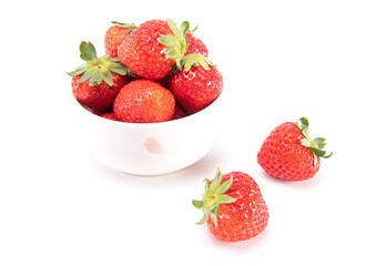 Fresh ripe strawberries in ceramic bowl and on white background. japanese fruit. Selective focus