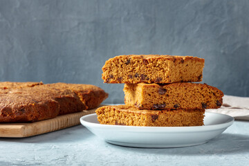 Blondie brownie dessert bars with chocolate chips, a side view of a stack on a plate