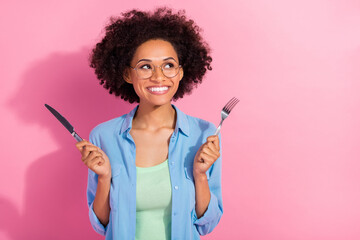 Photo of dreamy inspired cute lady hold fork knife look empty space think lunch wear denim shirt...