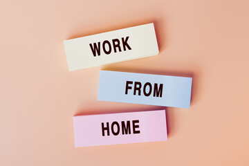 Work from home. Concept of text on color cards. Top view image of cards and on pastel beige background. Flat lay design