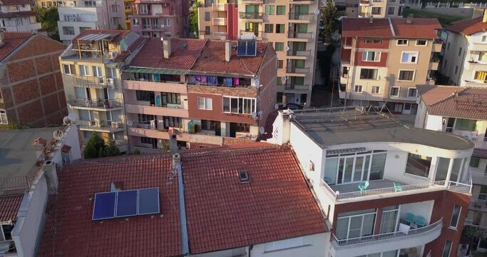 Drone aerial video of the tipical Bulgarian buildings and roofs with solar panels, south of Bulgaria. Alternative energy concept.