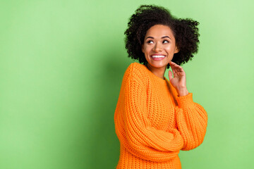 Photo of nice young volume hairdo lady look advert wear orange jumper isolated on green color background