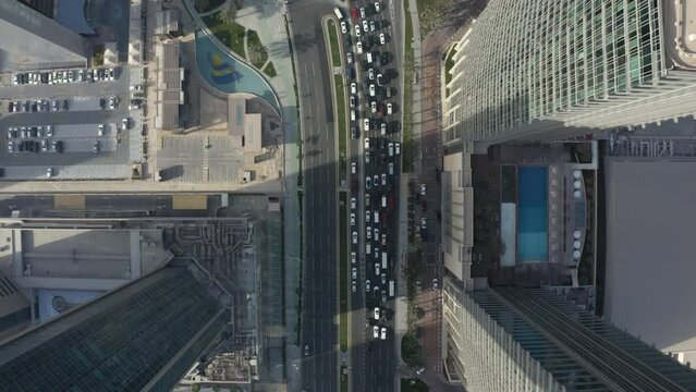 Top down drone shot in Dafna, a district in the city of Doha, Qatar. Full of urban, high-rise towers, buildings, offices and lots of urban structure.