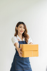Portrait of a small business startup, SME owner, female entrepreneur holding a box on white background, online purchase concept to prepare a box. Sell to customers. SME business online