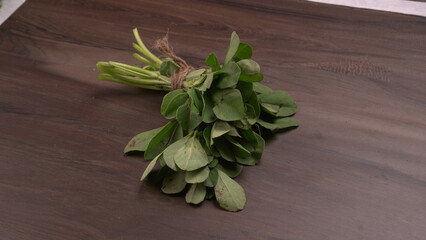 Bundle of fresh spinach isolated on wooden background. Vegan food lifestyle concept, Copy space.