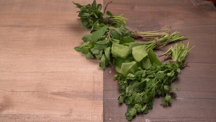 Bundle of fresh spinach isolated on wooden background. Vegan food lifestyle concept, Copy space.