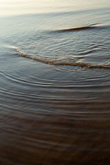 Calm evening with sea water and ripples in early spring