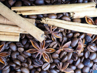 Background of coffee beans and spices: cinnamon sticks and star anise
