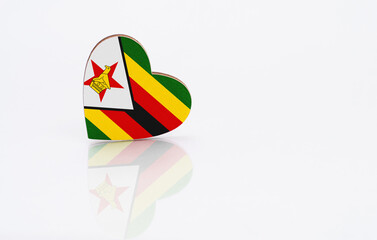 Flag of Zimbabwe in the shape of a heart on a white background. The concept of patriotism. copyspace.