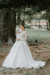 luxury stylish young bride on the background spring sunny green forest