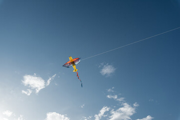A kite flying high in the sky in a nature reserve. Happy outdoor recreation. Freedom and space.