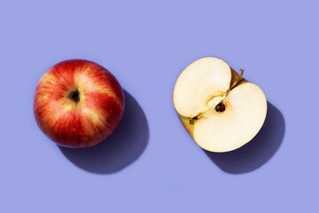 Fruit pattern red apple on trendy purple background. Violet and red colors background from fruity apple. Demonstrating the very peri, colors of 2022.