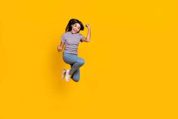Full body photo of young cheerful girl celebrate luck fists hands triumph discount isolated over yellow color background