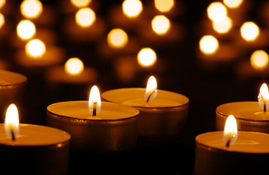 Many burning candles with bokeh light background