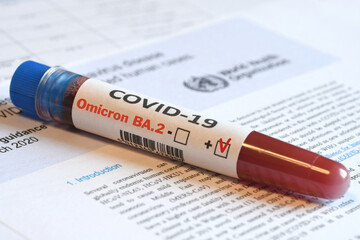 Blood tube for test detection of virus Covid-19 Omicron BA.2 Variant with positive result on papers...