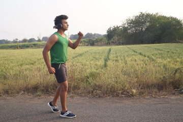 Young man in a sports outfit training outside.