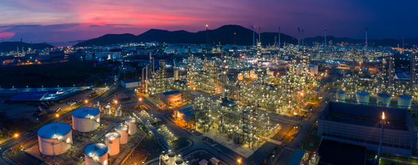 Fototapeta na wymiar Aerial view. Oil refinery factory and oil storage tank at twilight and night. Banner panorama background 