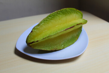 Carambola, or star fruit or 5 fingers, is the fruit of Averrhoa carambola. Green-yellow color.