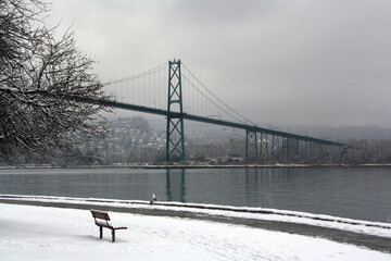 Lions Gate Bridge over a river on a cloudy day in Vancouver, British Columbia, Canada